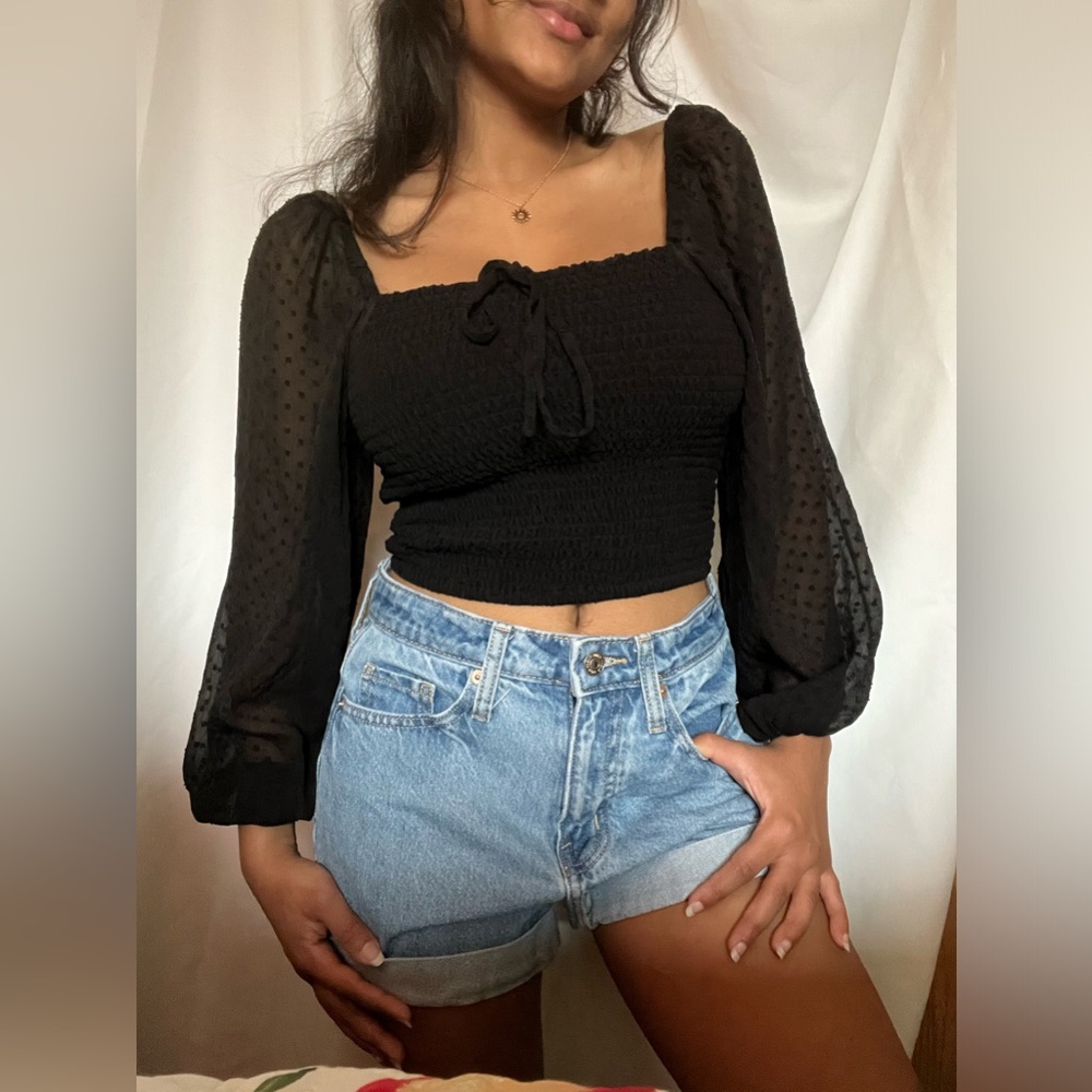 Black crop top. Very soft and had bubble sleeves that are see throught.